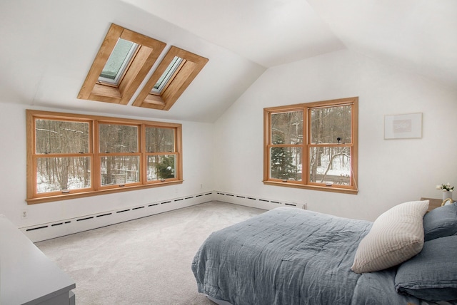 bedroom with baseboard heating, lofted ceiling with skylight, and carpet flooring