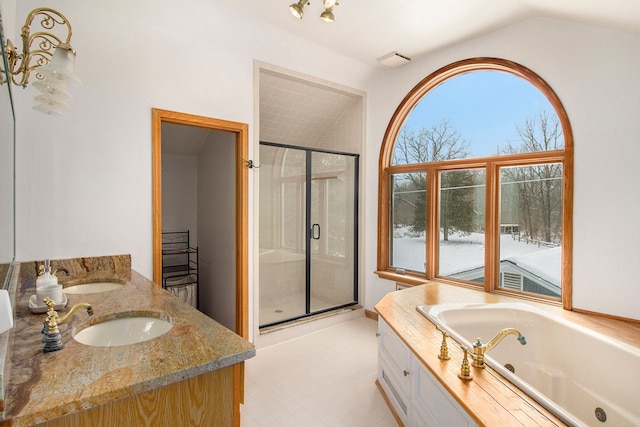 bathroom with vanity, vaulted ceiling, and plus walk in shower