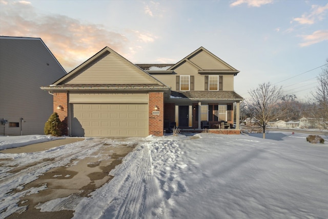 view of front property featuring a porch and a garage