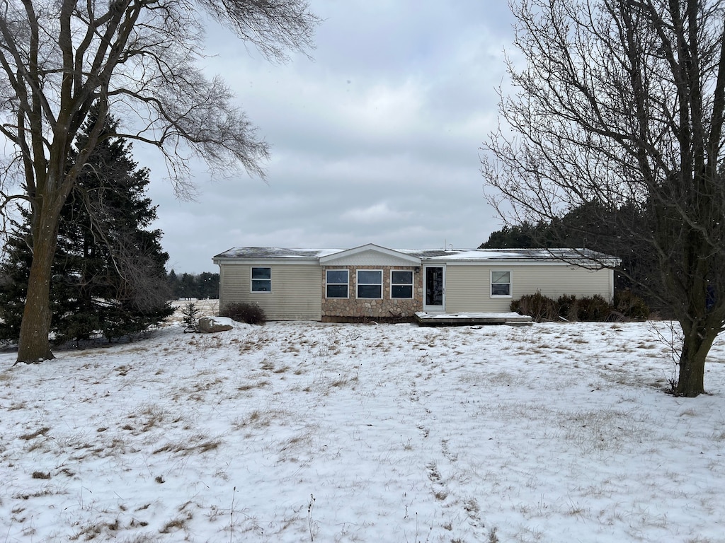 view of snow covered back of property