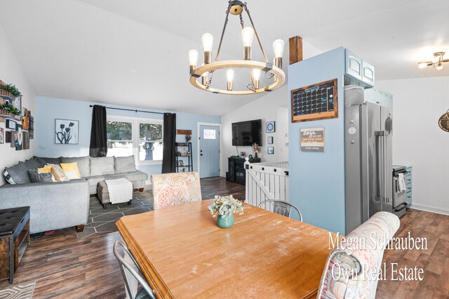 dining room with lofted ceiling, dark hardwood / wood-style flooring, and a notable chandelier