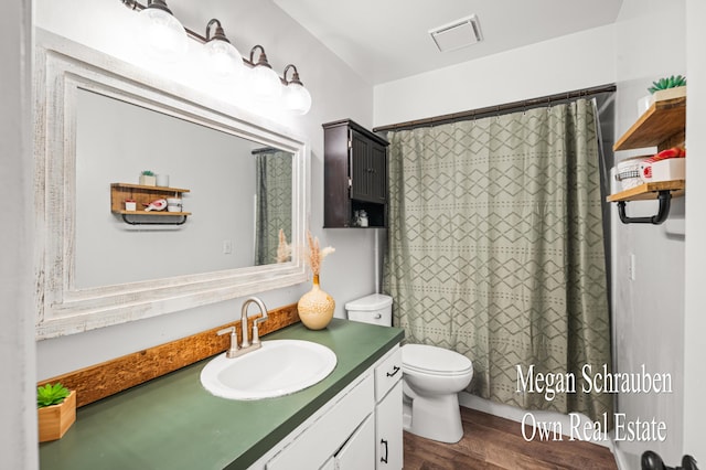 bathroom with toilet, a shower with shower curtain, vanity, and hardwood / wood-style floors