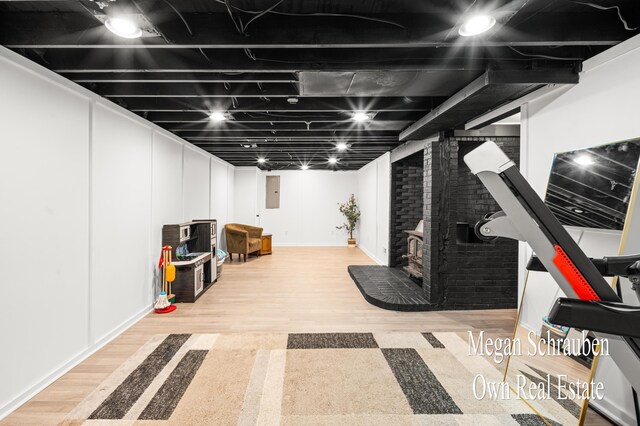 exercise area featuring electric panel and wood-type flooring