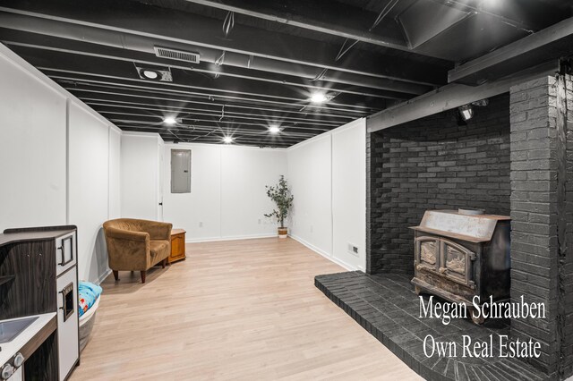 basement with hardwood / wood-style floors and electric panel