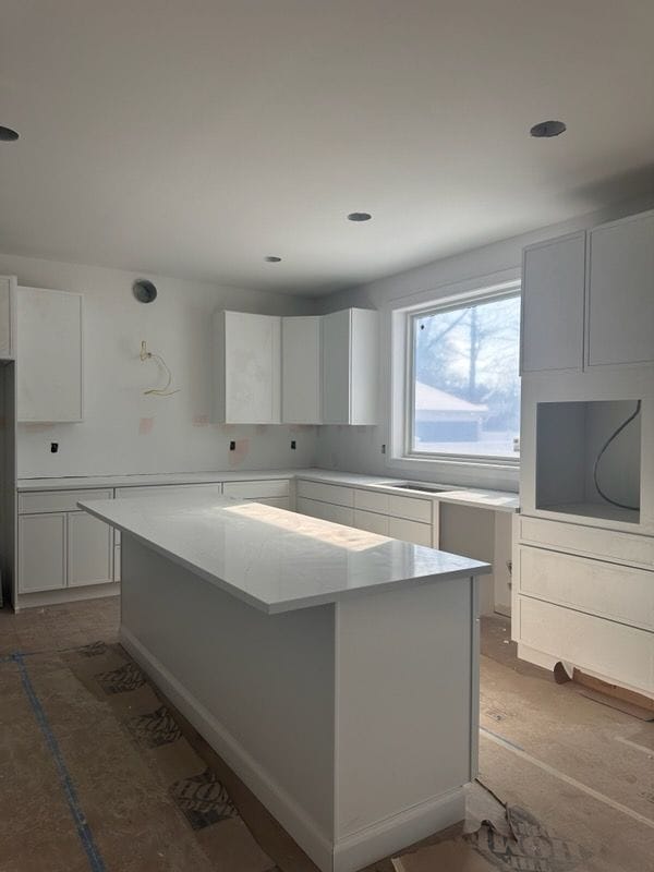 kitchen with white cabinetry and a kitchen island