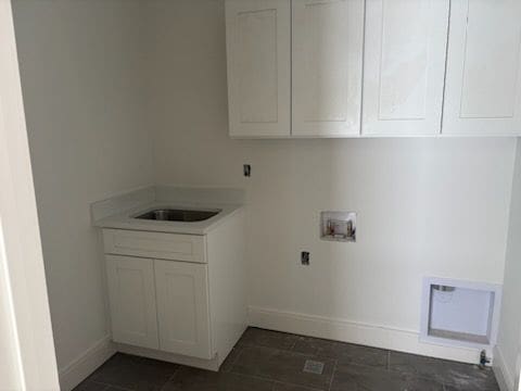 clothes washing area featuring hookup for a washing machine, electric dryer hookup, sink, and cabinets