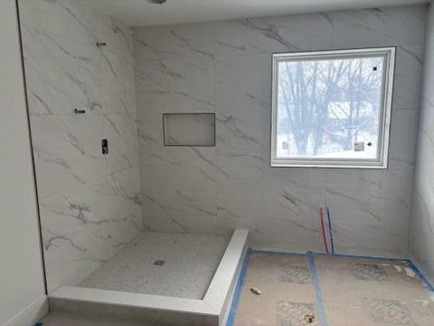 bathroom with a tile shower