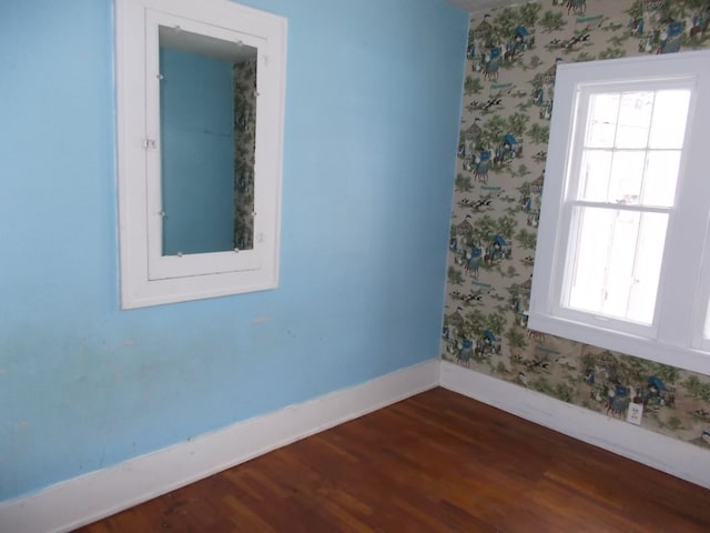 unfurnished room featuring dark hardwood / wood-style flooring