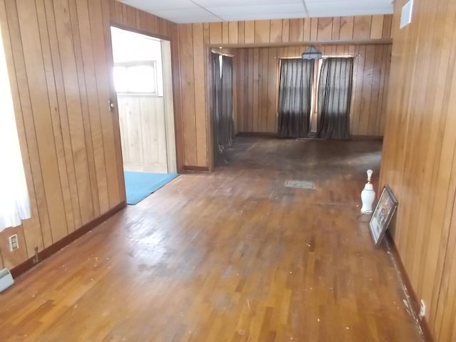 interior space featuring dark hardwood / wood-style floors and wooden walls