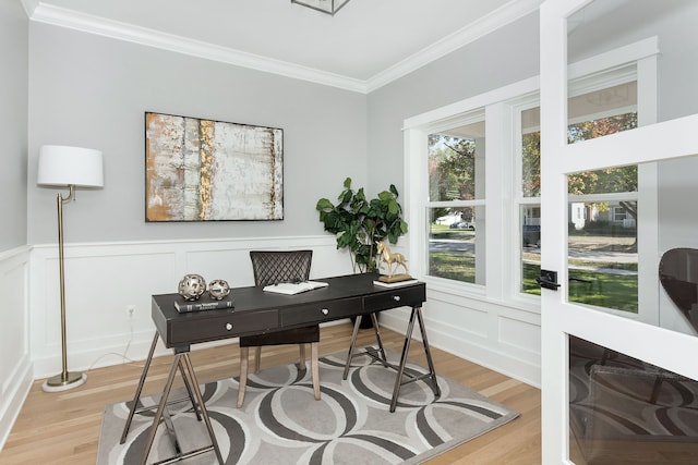 office with ornamental molding and light hardwood / wood-style flooring