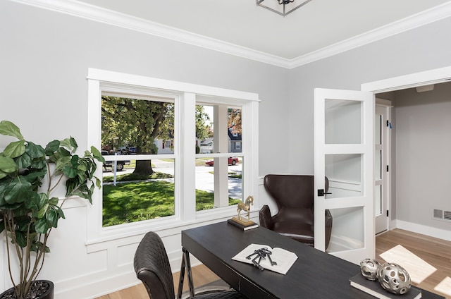 office with wood-type flooring and crown molding