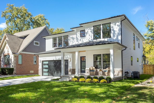 rear view of property with a porch, central AC, a lawn, and a garage