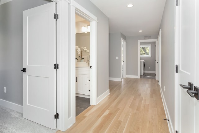 corridor featuring light hardwood / wood-style floors