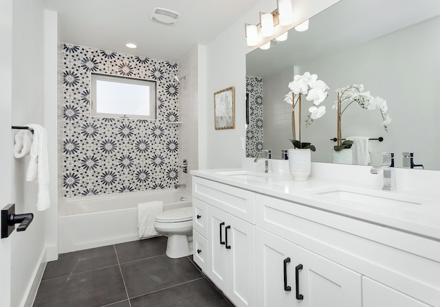 full bathroom featuring tile patterned flooring, toilet, vanity, and tiled shower / bath