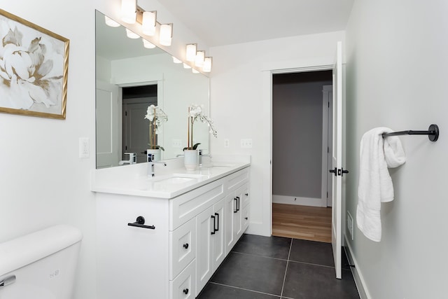 bathroom with vanity, tile patterned flooring, and toilet