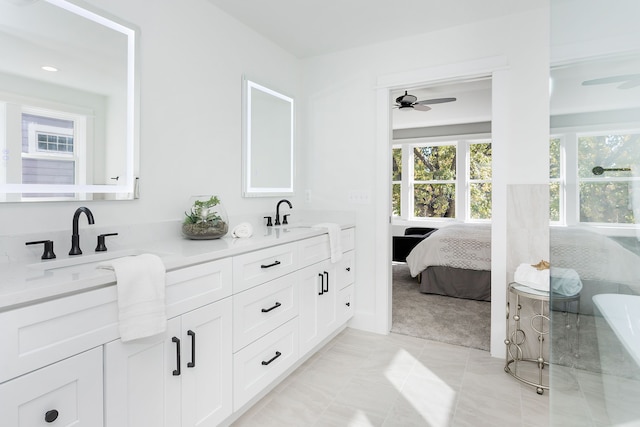 bathroom with tile patterned flooring, ceiling fan, and vanity