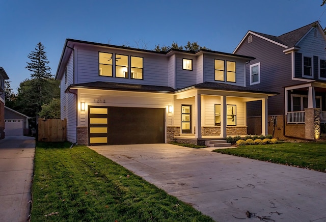 view of front of house featuring a garage and a yard