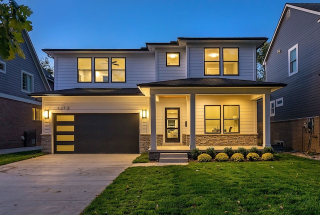 view of front of house featuring a garage and a yard