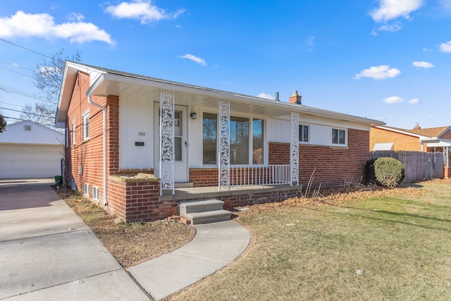 view of front of home featuring a garage, covered porch, an outdoor structure, and a front lawn