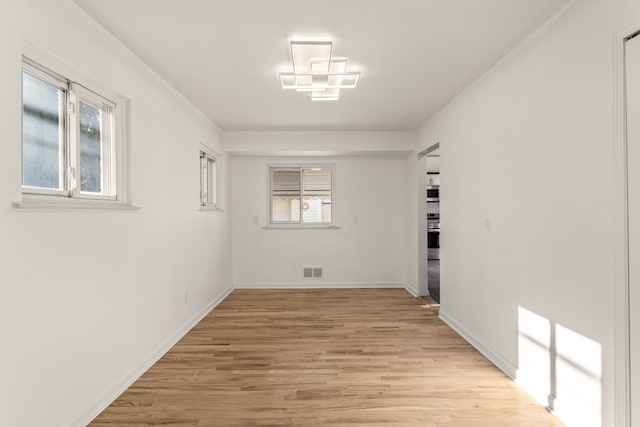 unfurnished room with light wood-type flooring and a healthy amount of sunlight