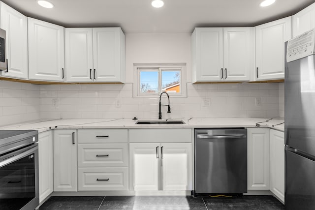 kitchen featuring stainless steel appliances, white cabinets, and sink