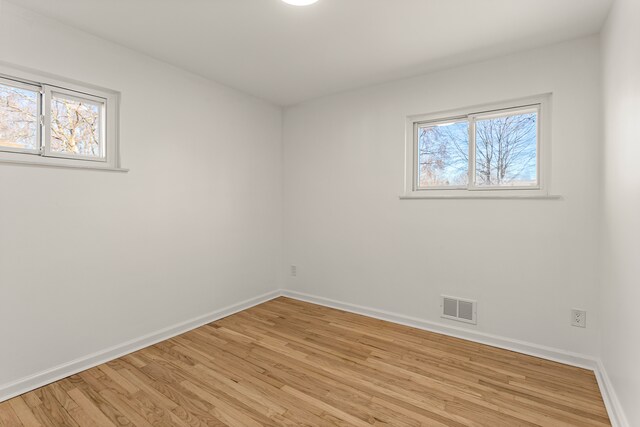 empty room with light hardwood / wood-style flooring