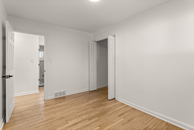 unfurnished bedroom with light hardwood / wood-style floors and a closet