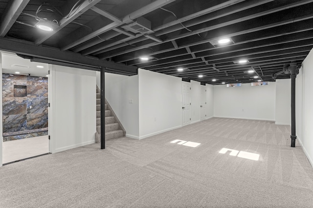 basement with light colored carpet