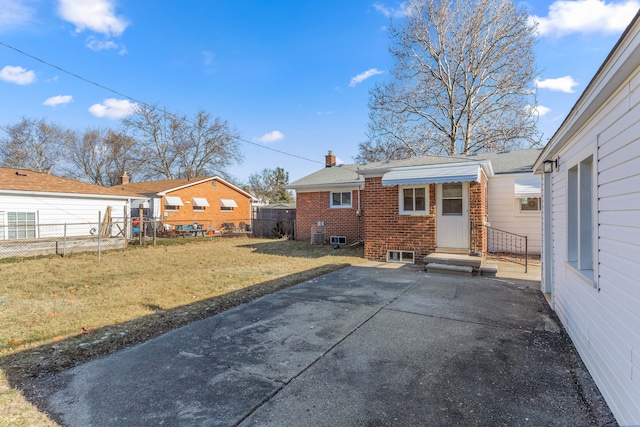 back of property featuring a yard and a patio