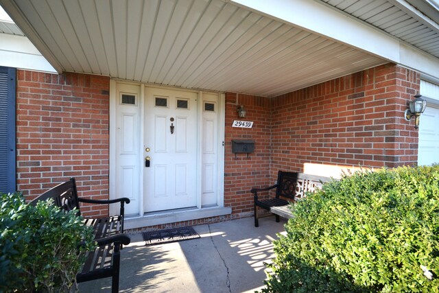 view of exterior entry with covered porch