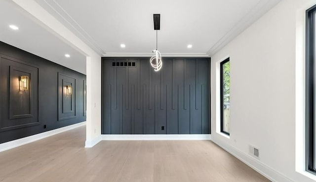 interior space with ornamental molding and light wood-type flooring