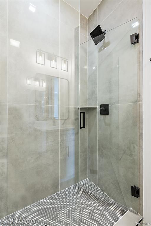 bathroom featuring a shower with shower door