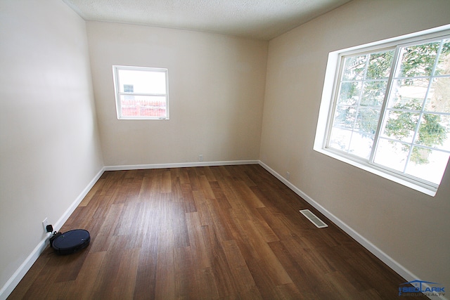 unfurnished room with dark hardwood / wood-style floors