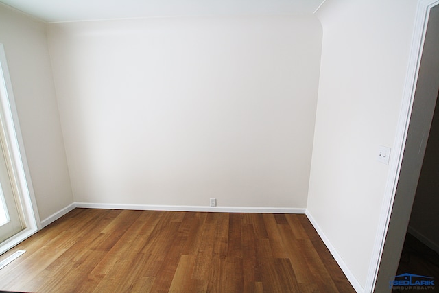 spare room with wood-type flooring