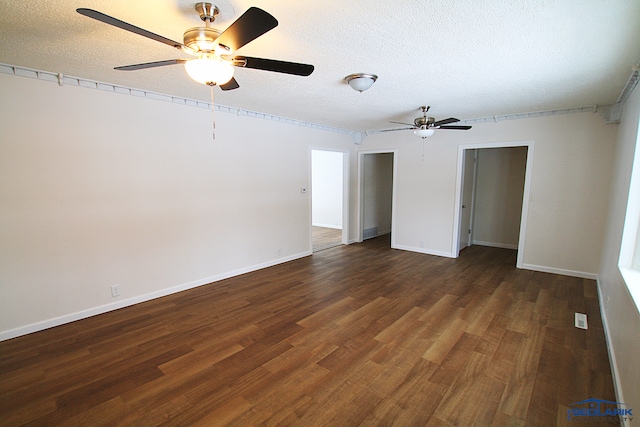 spare room with dark hardwood / wood-style flooring, a textured ceiling, and ceiling fan