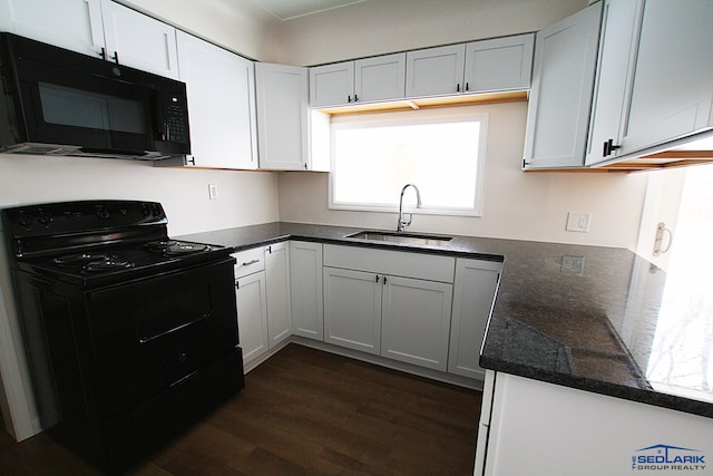 kitchen featuring sink, white cabinetry, dark stone countertops, dark hardwood / wood-style flooring, and black appliances