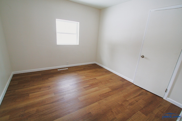 unfurnished room featuring wood-type flooring