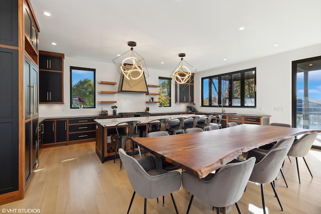 dining area featuring sink and light wood-type flooring