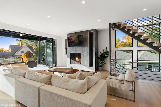 living room featuring a premium fireplace and light hardwood / wood-style floors