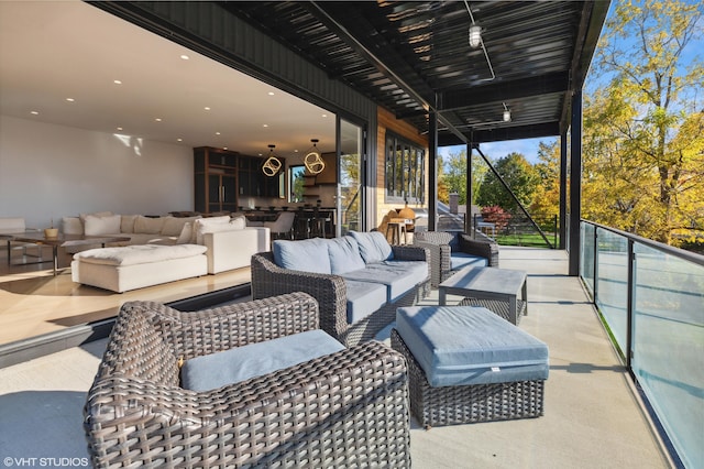 view of patio with a balcony and an outdoor hangout area