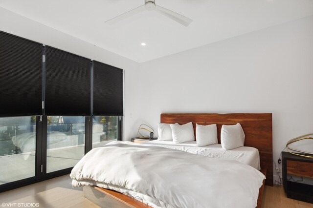 bedroom with access to outside, ceiling fan, and light wood-type flooring