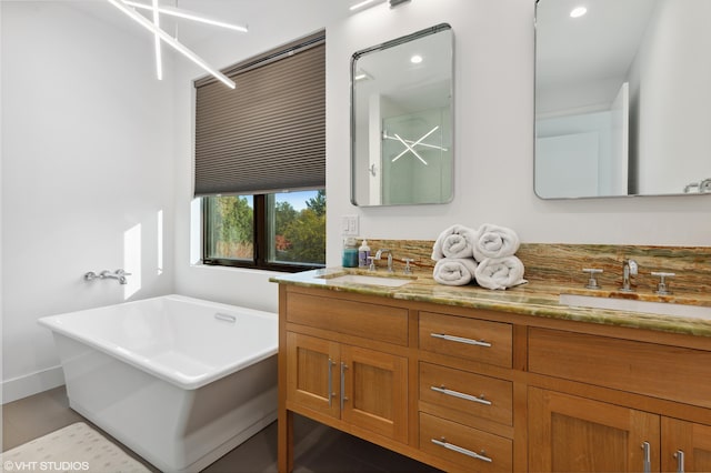 bathroom with vanity and a bath