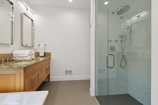 bathroom featuring a shower with door and vanity