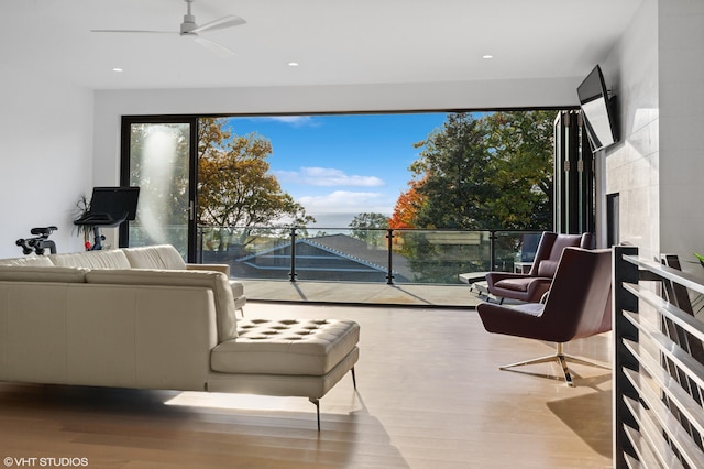 living room with light hardwood / wood-style floors and ceiling fan