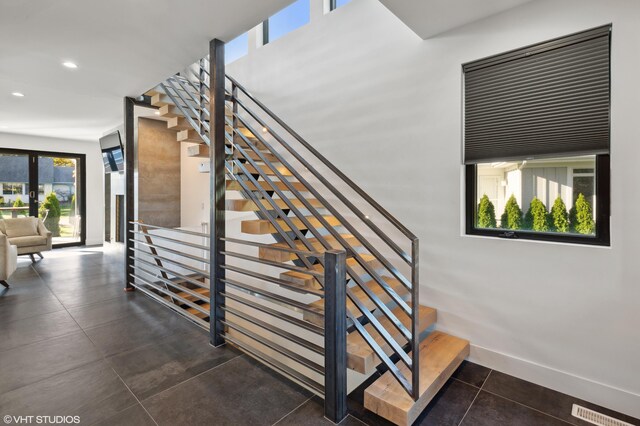 stairs with tile patterned flooring and french doors