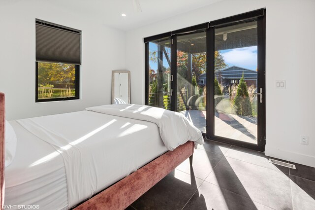 tiled bedroom featuring access to outside