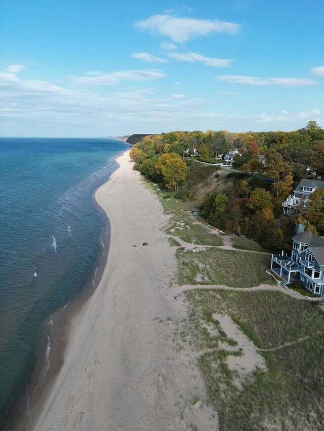 birds eye view of property featuring a water view and a beach view