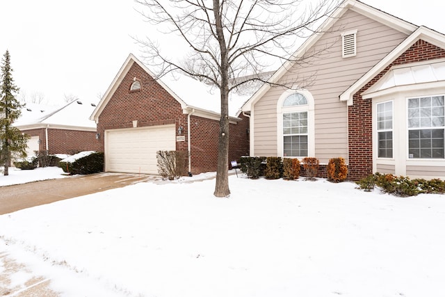 view of front of property with a garage and brick siding