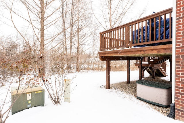 yard layered in snow with a deck