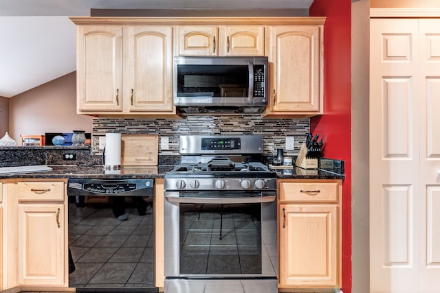 kitchen featuring dark stone counters, tile patterned flooring, appliances with stainless steel finishes, and light brown cabinets